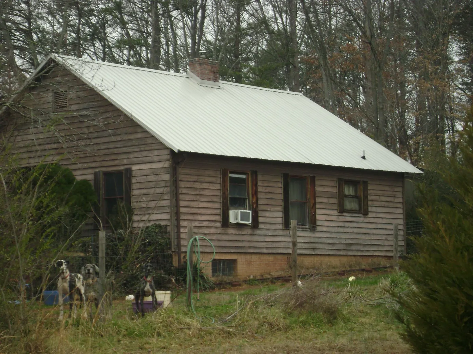 White metal roof on an old wood sided farmhouse, from a Metal Roof Installation job in Frankfort